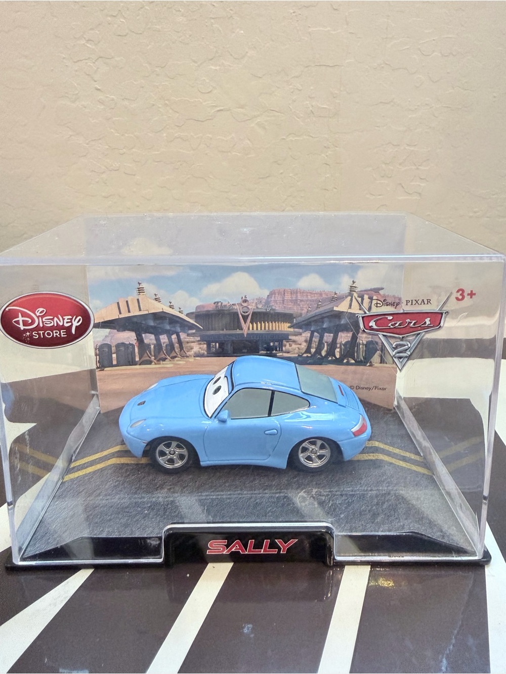 Disney Store Cars Sally Light Blue Die-Cast Car in a case.
